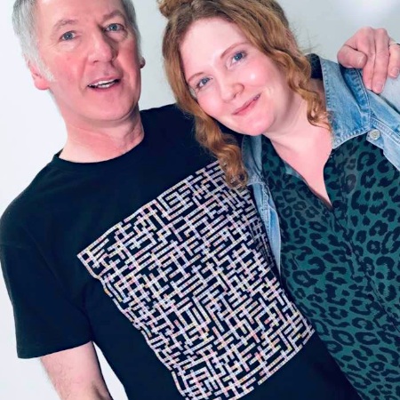 photo of clint boon wearing manchester bands name-chains black t-shirt with jennie mcalpine