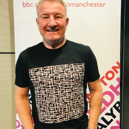 image of mike sweeney wearing manchester bands name-chains black t-shirt